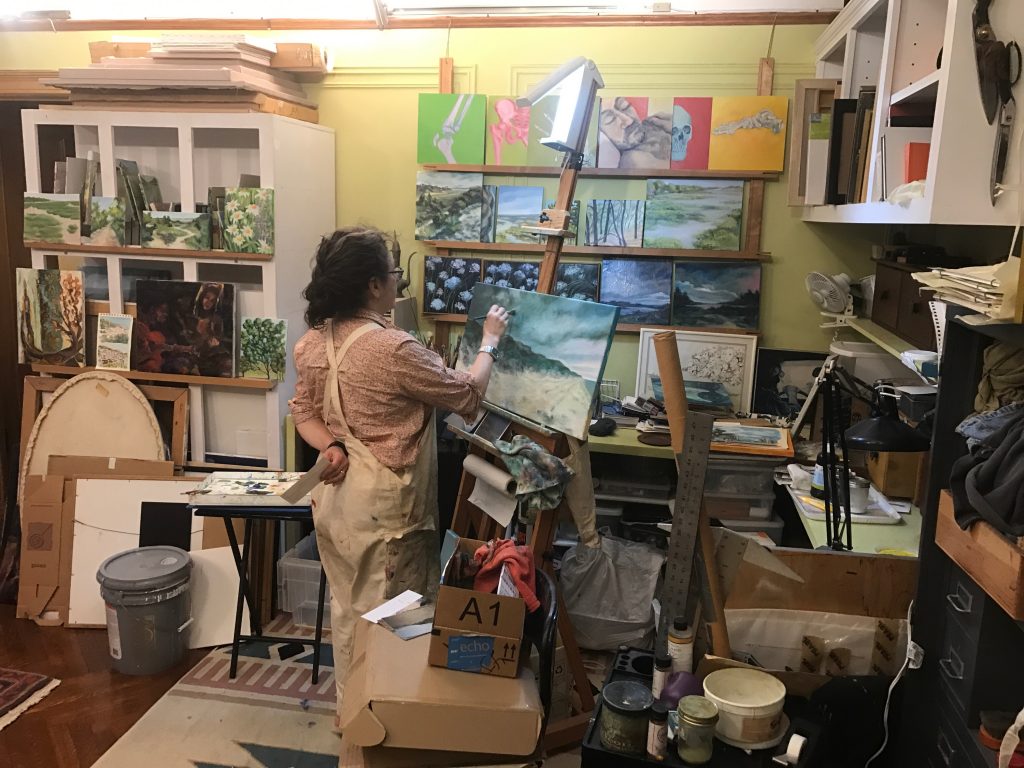 Lydia painting in her studio (aka our living room)