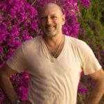 Leslie standing in front of a pink bougainvillea bush