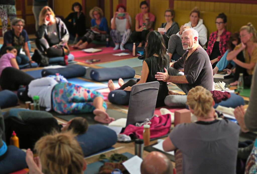 Leslie working with a single student surrounded by others.